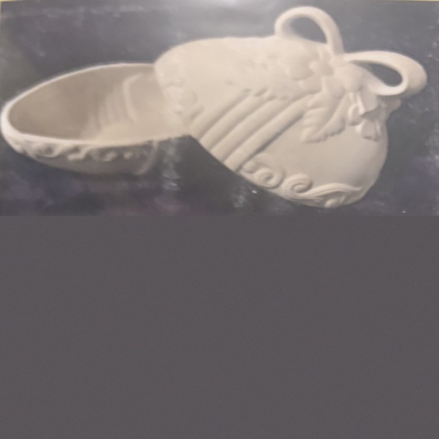 Egg box, number 98, unpainted bisque on black velvet