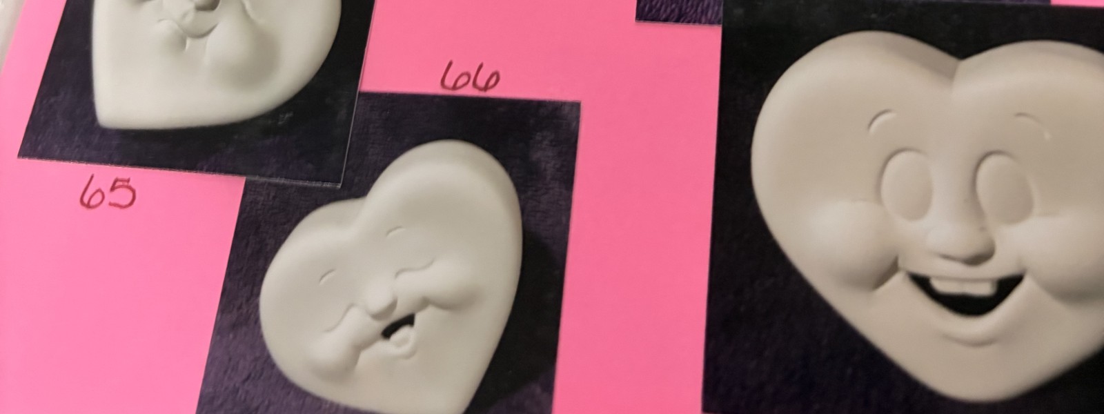 Heart faces, unpainted bisque, photographed on black velvet